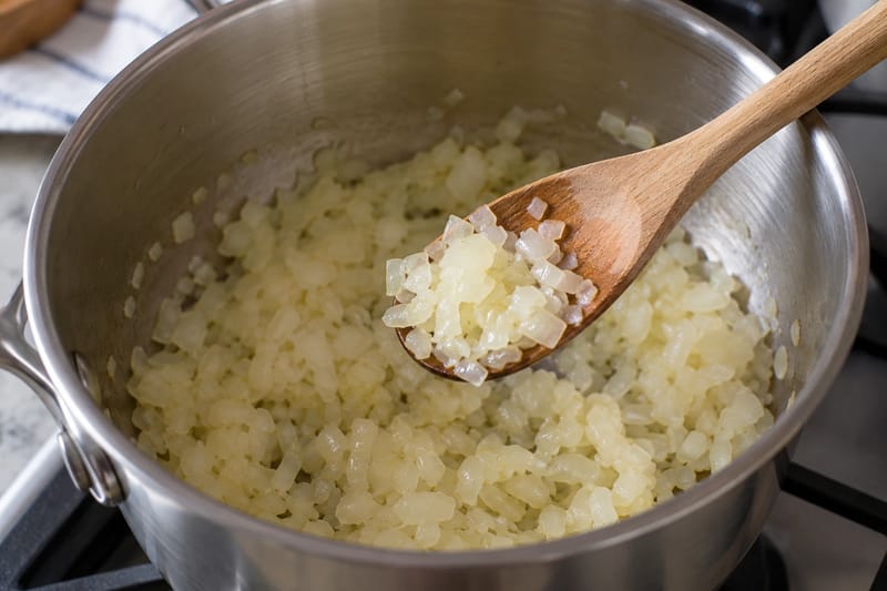 Pale, softened onion pieces with no browned edges.